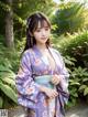 A woman in a purple kimono posing for a picture.