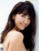 A woman with long brown hair posing for a picture.