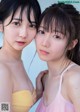 Two young women standing next to each other on a beach.