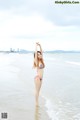 A woman in a bikini standing in the ocean.